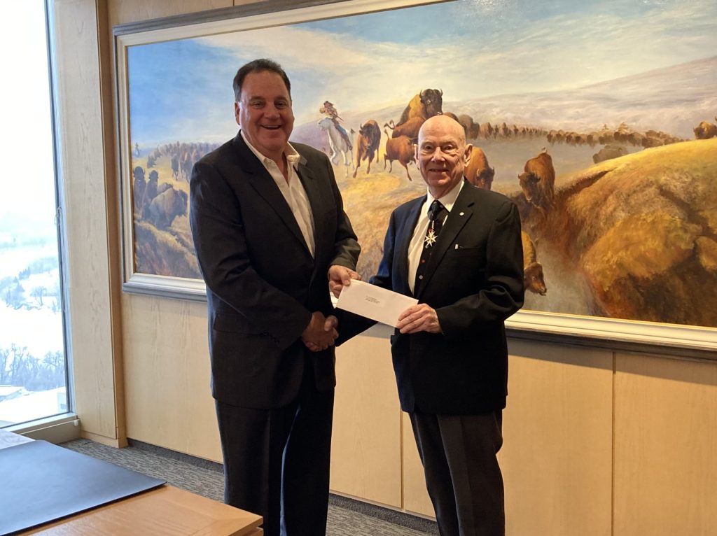 Andrew Paterson presenting a $10,000 donation to Bob Vandewater of St. John’s Ambulance