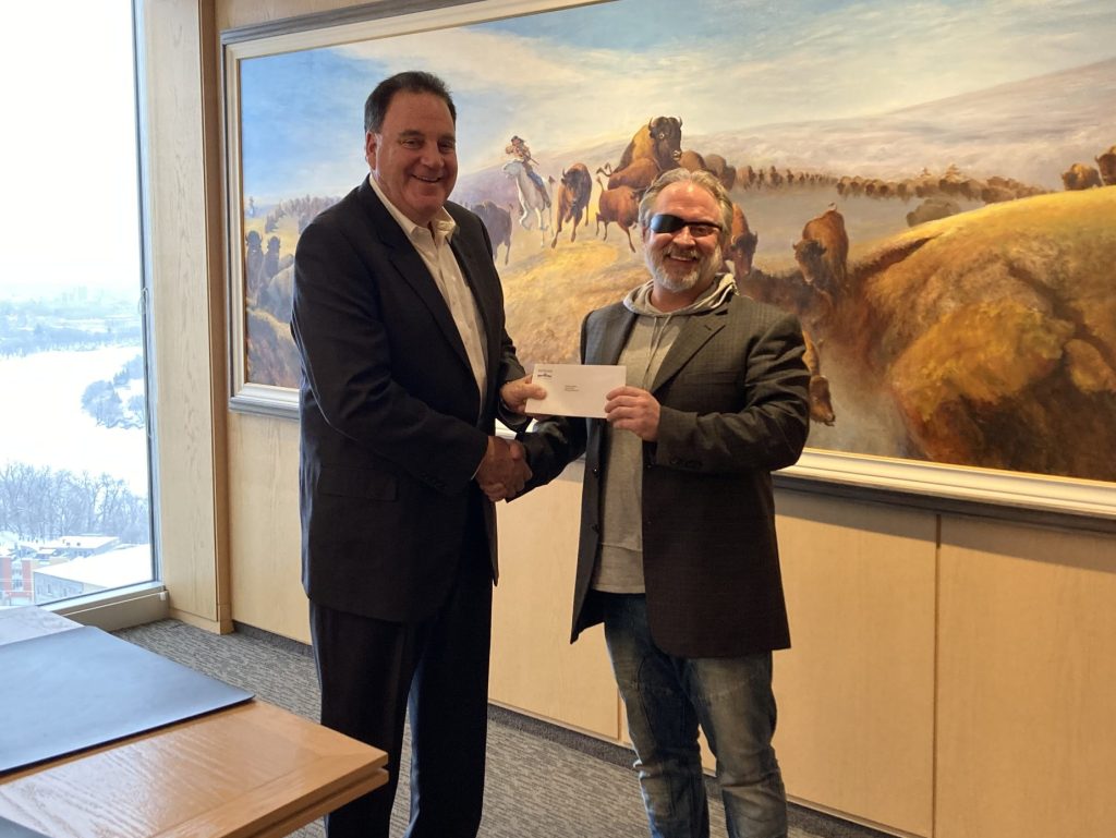 Andrew Paterson presenting a $30,000 donation to Jon Einarson of The Grace Hospital
