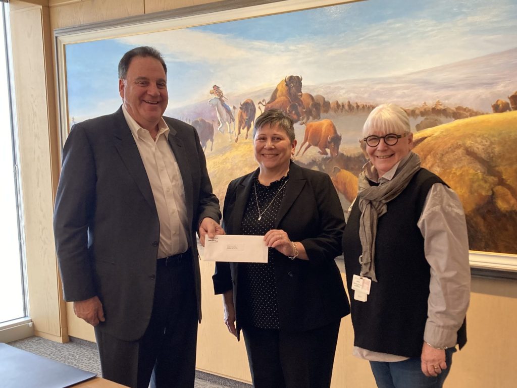 Andrew Paterson presenting a $30,000 donation to Karen Fowler and Shona Connelly of St. Boniface Hospital Foundation