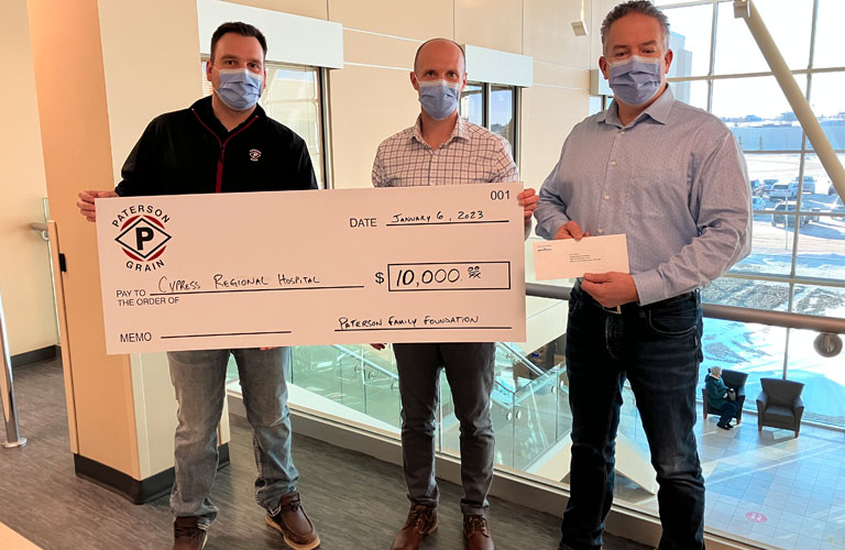 Adam Thompson (Paterson Grain Swift Current GM) & Warren Mareschal (Paterson Grain Region Manager) presented a cheque for $10,000 to Curtis Newton, the manager of Primary Health for Cypress Health Center.